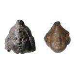 Roman, bronze heads of Cupid (2), 2nd century AD, young god with cherubic face and curly hai...