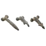 Roman, bronze phallic pendants (3), 2nd century AD, all moulded in the round with a slightly...