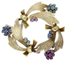 A gem-set brooch, the openwork brooch of stylised foliate sprays with polished ribbon connec...