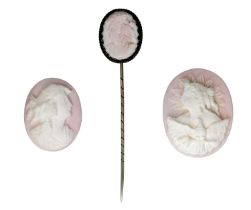 Two unmounted shell cameos and a shell cameo set stickpin, the first carved with the Allegor...
