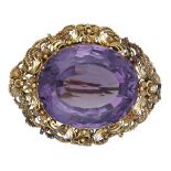 A 19th century amethyst brooch, circa 1830, the oval mixed-cut amethyst within a gold cannet...