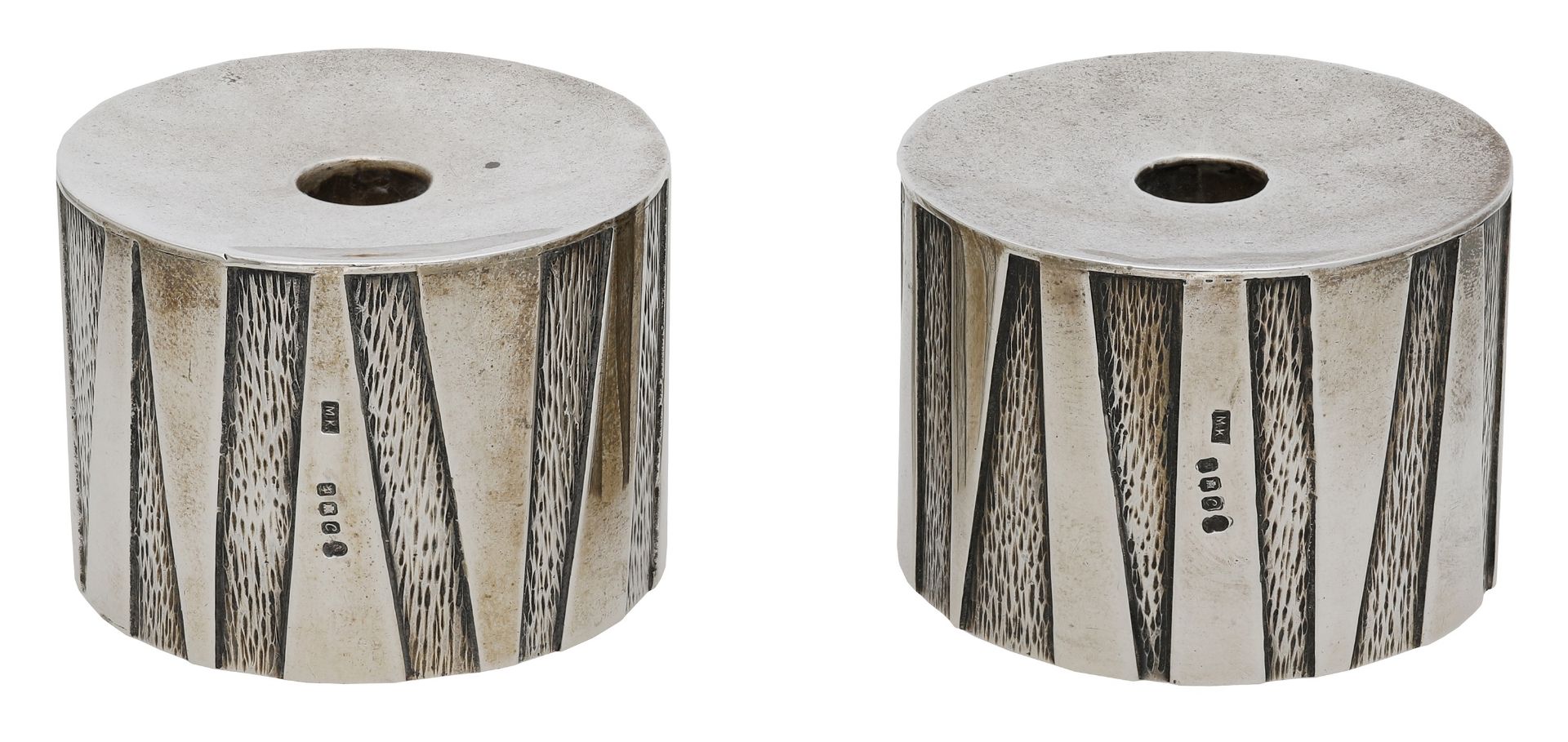 A pair of silver tapersticks by Michael Kay, 1977, of squat cylindrical form, the sides with...