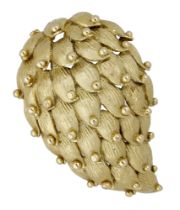 An abstract brooch, circa 1960, the bombÃ© brooch composed of overlapping textured petals, wi...