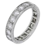 A diamond eternity band, set with brilliant-cut diamonds with scroll engraved gallery, numbe...