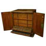 A wooden collector's cabinet, 48 x 45 x 32cm, comprising 19 flat trays, each divided into sq...