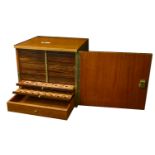 A mahogany coin cabinet, 33.5 x 30.5 x 31.5cm, comprising 24 trays double-pierced to house a...