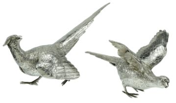 A matched pair of silver ornaments, a cock and hen pheasants, realistically modelled, the co...