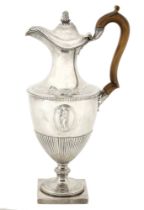 A George III silver ewer, the shouldered half-lobed body applied with two oval medallions ca...