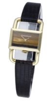 Jaeger-LeCoultre. A lady's gold rectangular wristwatch with tiger's eye dial and stirrup lug...