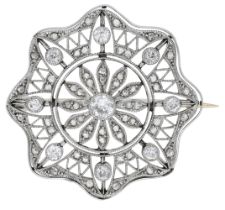 A diamond brooch, circa 1915, the pierced circular plaque with knifewire detailing and set t...