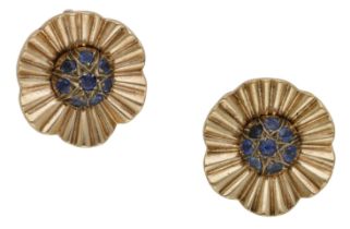 A pair of sapphire ear clips, circa 1940, the stylised flowerheads with a bombÃ© centre of ci...