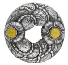 A Danish silver brooch by Georg Jensen, the circular wreath design with two yellow cabochon...
