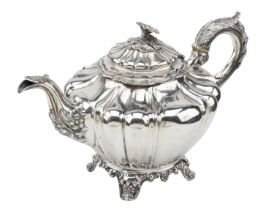 A Victoria silver tea pot, with flower finial, lobed body and flowerhead and foliage decorat...