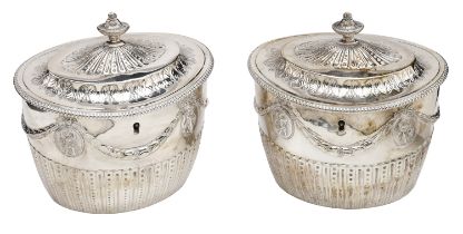 A pair of George III silver tea caddies, oval and of neo-classical design, the hinged lids w...