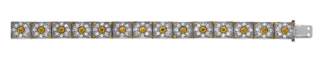 A paste bracelet, the square links each set with a circular-cut white and yellow paste flowe...