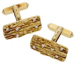 A pair of diamond cufflinks, 1968, each 18ct gold rectangular plaque with a textured bark fi...