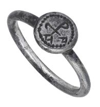 A late Byzantine 10th/11th century silver ring, the circular sectioned hoop and round bezel...