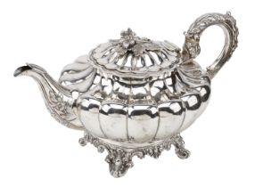 A Victoria silver tea pot, with flower finial, lobed body, flower and foliage decorated hand...