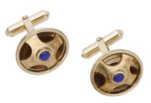 A pair of lapis lazuli set cufflinks, the hollowed domed roundels of pierced quatrefoil desi...