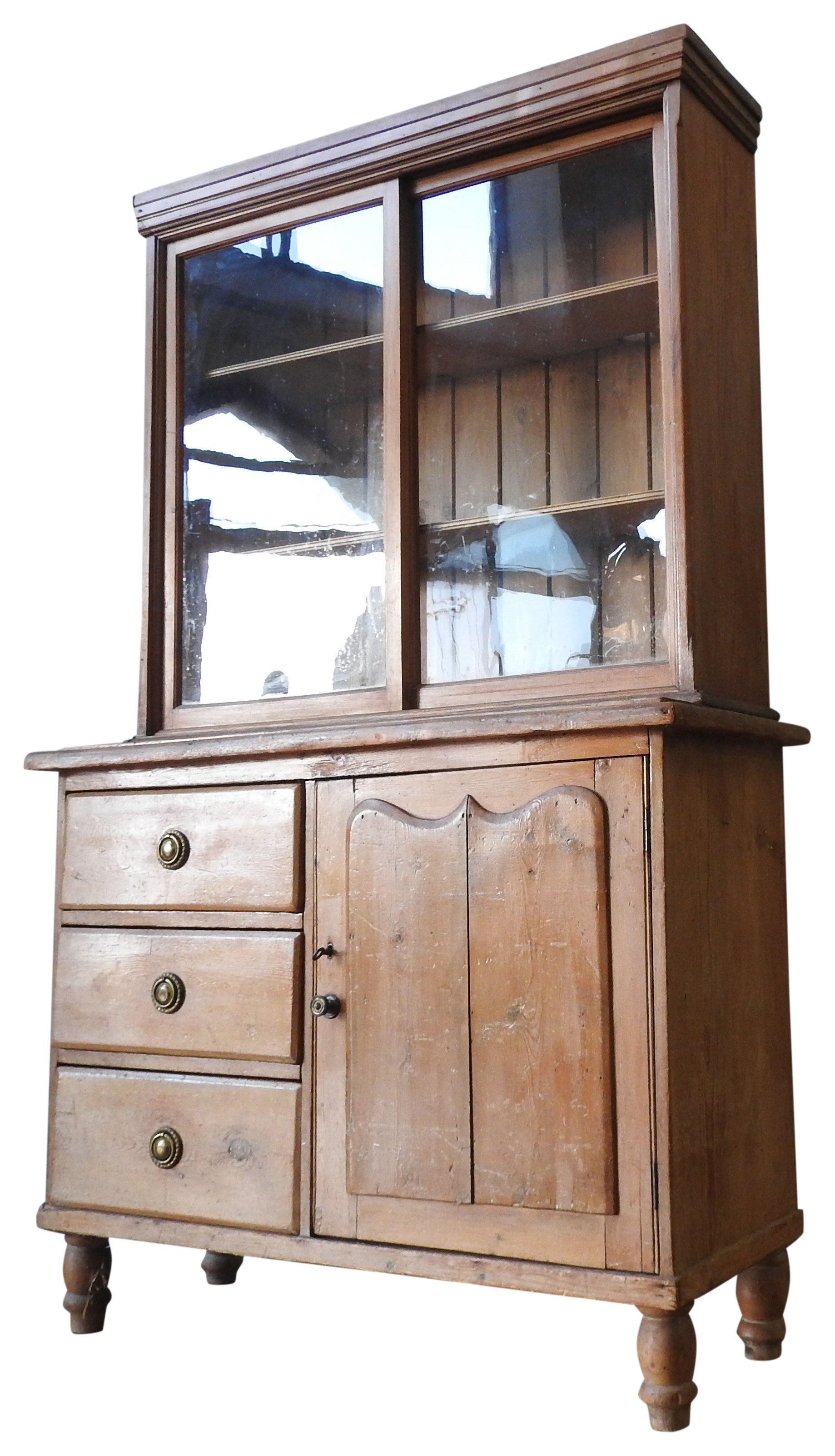 A PINE BOOKCASE ON 19TH CENTURY CONTINENTAL PINE CUPBOARD, the bookcase with two glazed sliding