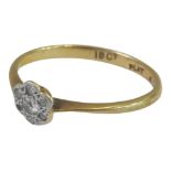 AN 18CT GOLD DIAMOND CLUSTER RING, a small central stone surrounded by five diamond chips (one