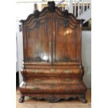 A DUTCH EARLY 19TH CENTURY MAHOGANY LINEN PRESS, the arch stepped cornice sat over two arch molded