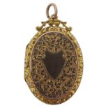 A 19TH CENTURY GOLD FILLED OVAL LOCKET, with engraved profuse floral decoration and shield