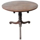 A 19TH CENTURY OAK TRIPOD TABLE,  circa 1850, the circular top raised on a turned baluster pillar,