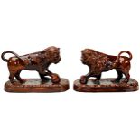 A PAIR OF STAFFORDSHIRE TREACLE-GLAZE LIONS 19TH CENTURY the confronting beasts standing with one