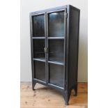 A CONTEMPORARY STEEL CABINET, simplistic Industrial style, with two glazed doors enclosing two