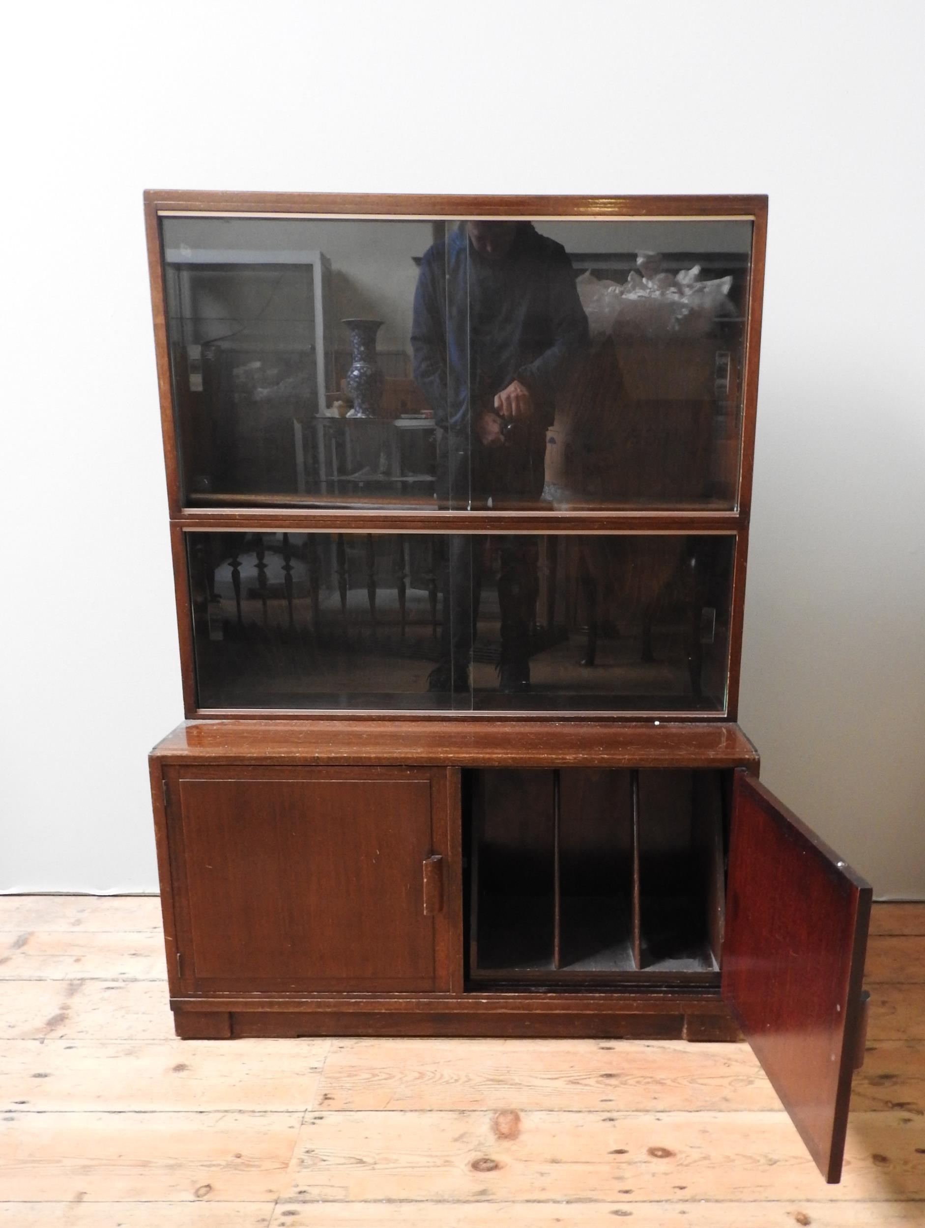 A MODULAR MID CENTURY MAHOGANY BOOKCASE, with two top sections with sliding glass doors, sat atop - Image 2 of 3