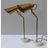 A PAIR OF POLS POTTEN TABLE LAMPS, adjustable angle brass fittings on a circular marble base, 60