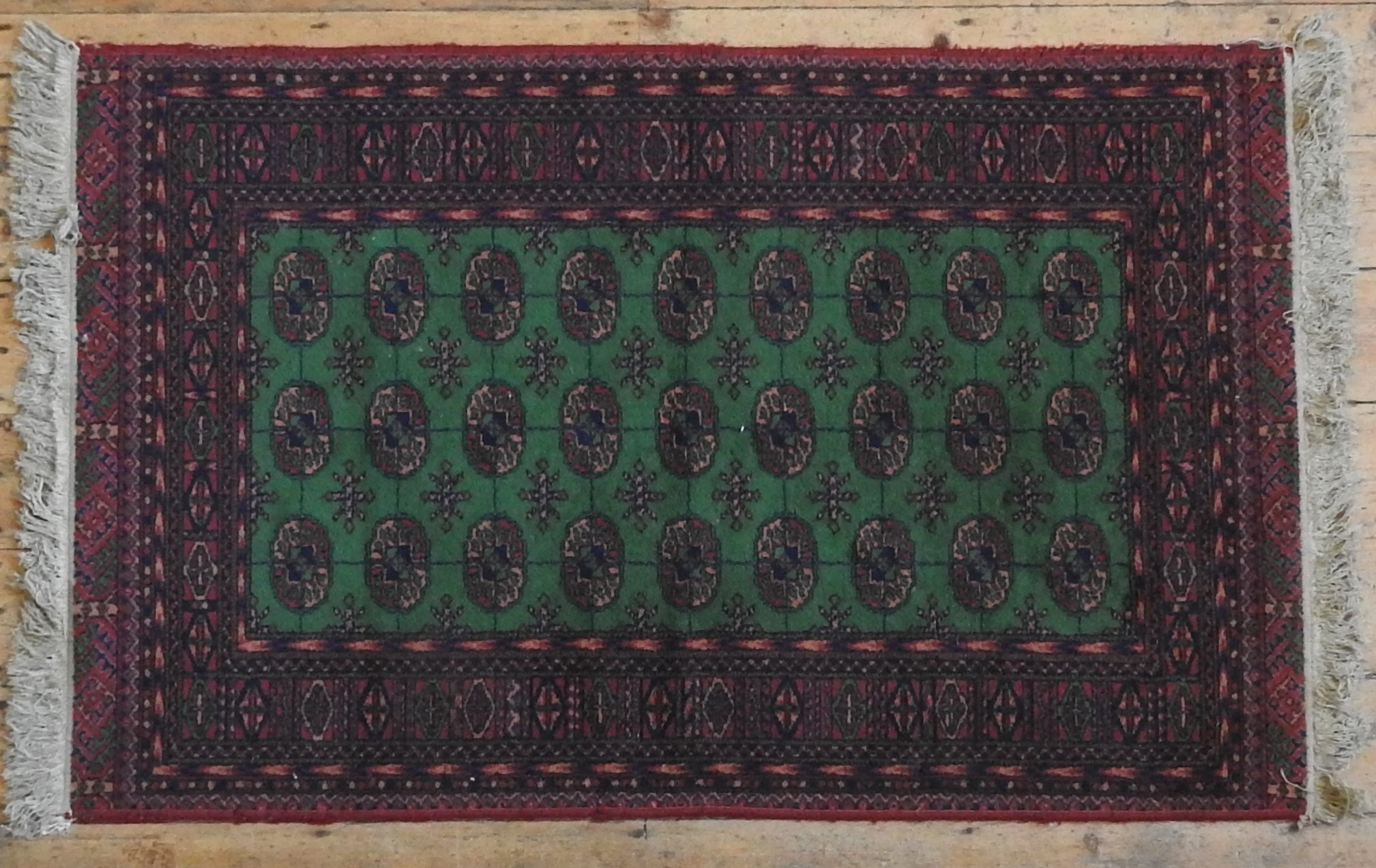 A CONTEMPORARY BOKHARA RUG, the central panel decorated with three rows of nine gulls, on a