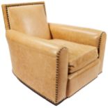 A RALPH LAUREN COLORADO LEATHER CLUB CHAIR covered in light tan leather with bold hammered nailheads