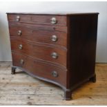 A GEORGE III MAHOGANY CHEST OF DRAWERS, serpentine form, comprised of four graduated long drawers,