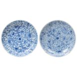 TWO BLUE AND WHITE SAUCER DISHES KANGXI PERIOD (1662-1722) each densely decorated with blossoming