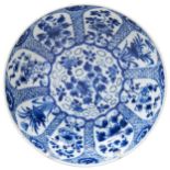 SMALL BLUE AND WHITE DISH KANGXI PERIOD (1662-1722) painted with panels of flowers reserved