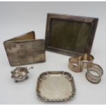 A SILVER CIGARETTE CASE, PICTURE FRAME AND RING DISH, along with three silver napkin rings and a