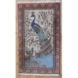 A PERSIAN OR INDIAN RUG, peacock decoration on a cream ground 125 x 64 cm