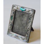 A SILVER PICTURE FRAME, with enamelled Art Nouveau floral decoration 19 x 15 cm