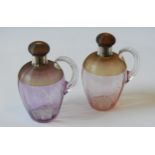 A PAIR OF 19TH CENTURY THREADED GLASS SPIRIT DECANTERS BY STEVENS AND WILLIAMS, cranberry tinged