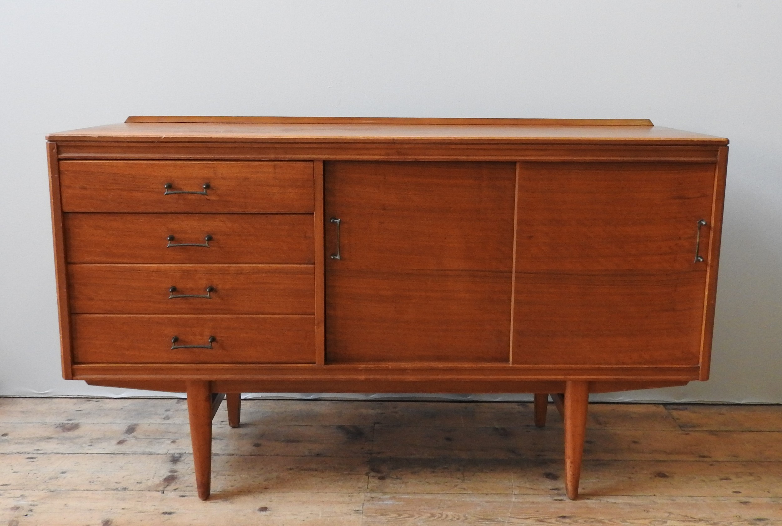 A TEAK MID CENTURY SIDEBOARD, circa 1960, four short drawers beside two sliding doors, enclosing two - Image 2 of 4