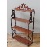 A VICTORIAN MAHOGANY WALL SHELF, the four sepentine shelves united by turned baluster pillars,