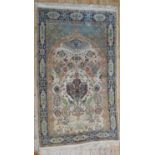 A PERSIAN PART SILK RUG, decoration depicting birds and a archway, on a cream ground 240 x 140 cm