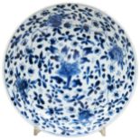 BLUE AND WHITE DISH KANGXI PERIOD densely painted in tones of underglaze blue with blossoming