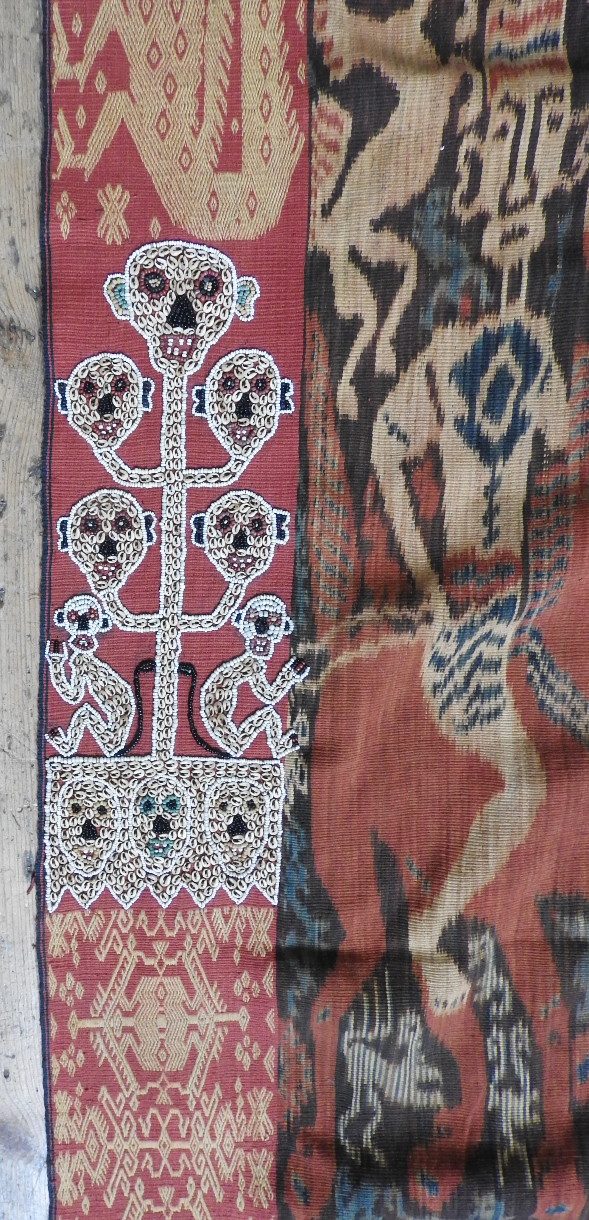 AN INDONESIAN IKAT WALL HANGING, 20th century, border decorated with grotesque figures, central Ikat - Image 2 of 3