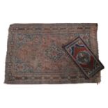 A WORN PERSIAN RUG AND A PRAYER RUG