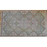 A PERSIAN DESIGN RUG, geometric design on pastel shades ground 173 x 100 cm