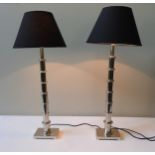 A PAIR OF CHROMED TALL TABLE LAMPS, contemporary graduated sectional design, raised on oblong plinth