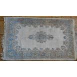 AN INDIAN CARPET, with floral decoration on a cream ground 283 x 155 cm